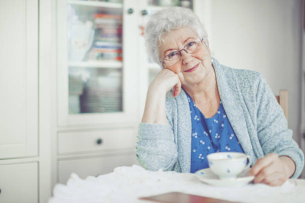 Senior woman living independently at home supported by 24/7 senior monitoring service.