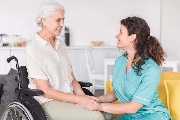 senior-woman-sitting-wheelchair-holding-nurse-s-hand_23-2147861535 (1)