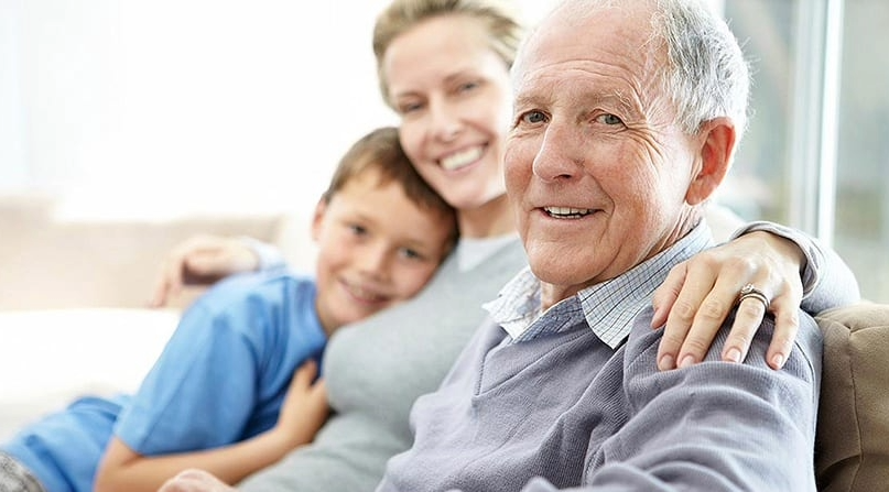 Older adult sitting at home with family members in Connecticut, reflecting supportive aging and memory awareness